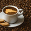 Cup of Cafe Santo Domingo 100% Puro Cafe hot coffee beverage with map of Dominican Republic, cookies and coffee beans