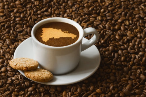 Cup of Cafe Santo Domingo 100% Puro Cafe hot coffee beverage with map of Dominican Republic, cookies and coffee beans